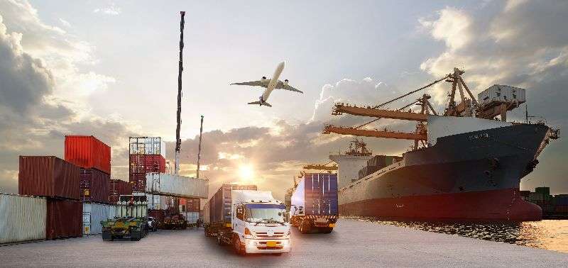 Shipping containers and trucks at a port with a cargo ship and airplane overhead, representing efficient import and delivery services for high-value items.