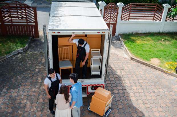 Jacksonville white glove delivery team unloading furniture from truck, showcasing careful handling of valuable items for residential and commercial clients.