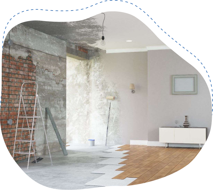 Interior space undergoing renovation with exposed brick wall, ladder, painting tools, and mixed flooring, illustrating the process of preparing for a move or home improvement.