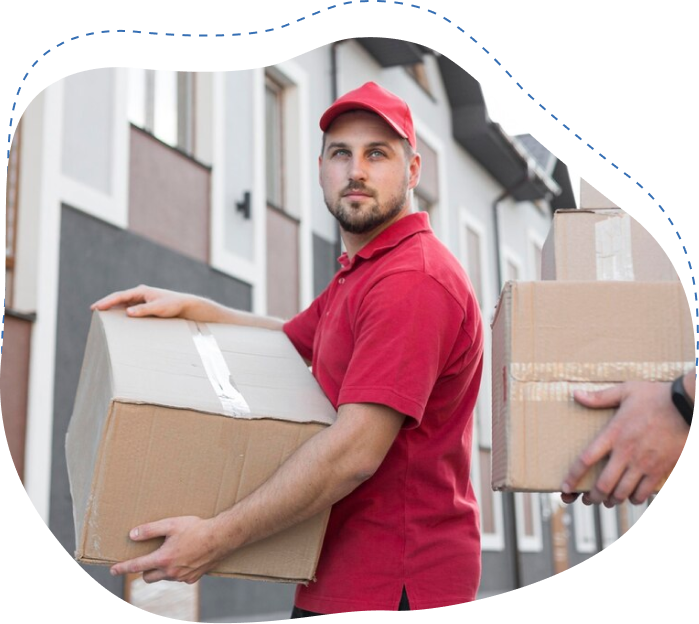 Man in red shirt and cap carrying cardboard box, representing reliable junk removal services in Jacksonville.