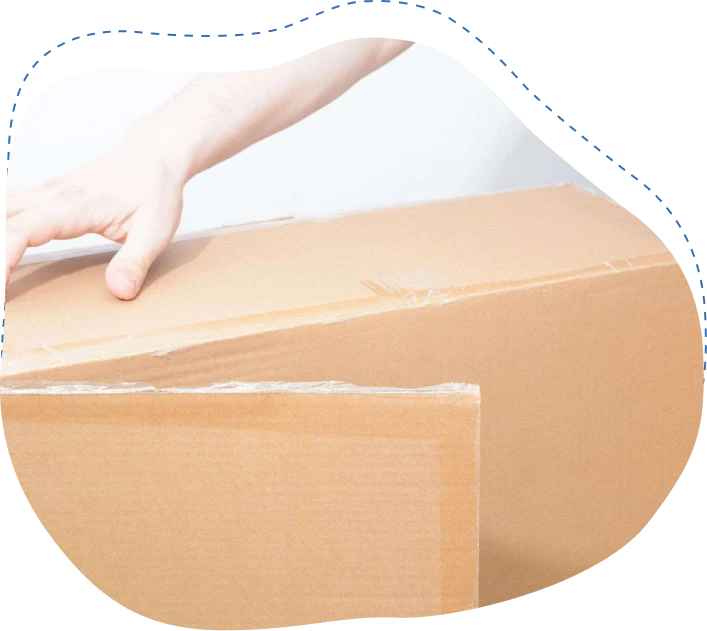 Hand reaching to close a cardboard box, symbolizing professional packing services by Skinner Moving in Jacksonville.